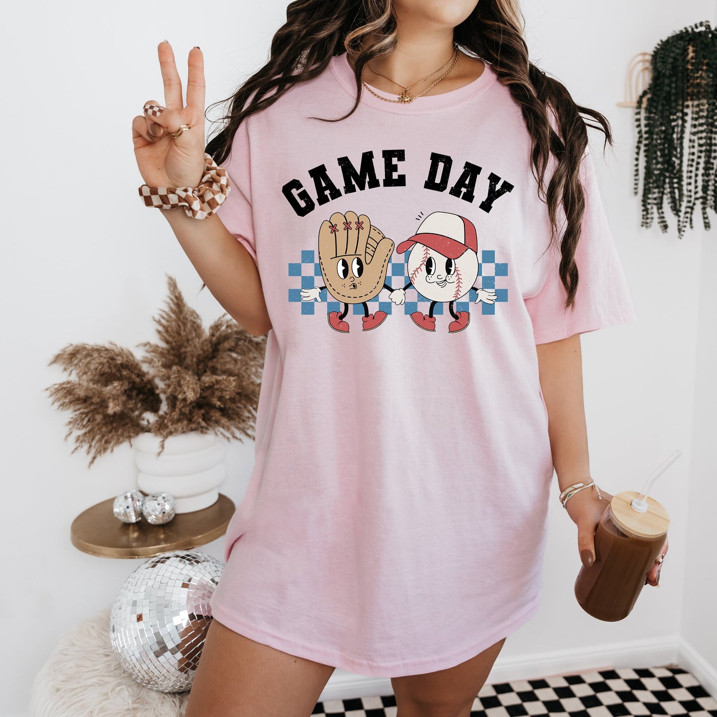a woman in a pink shirt holding a cup of coffee