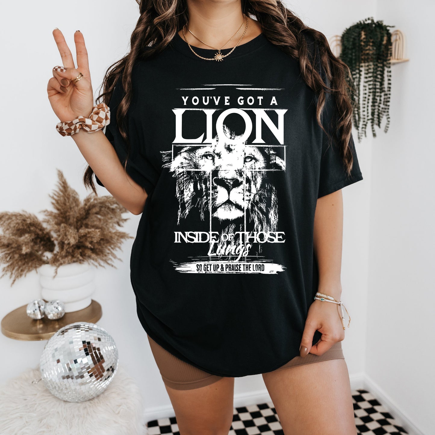 a woman wearing a black shirt with a lion on it