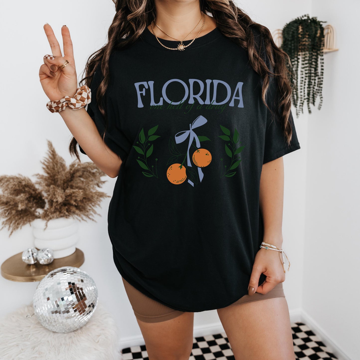 a woman standing in a room with a peace sign