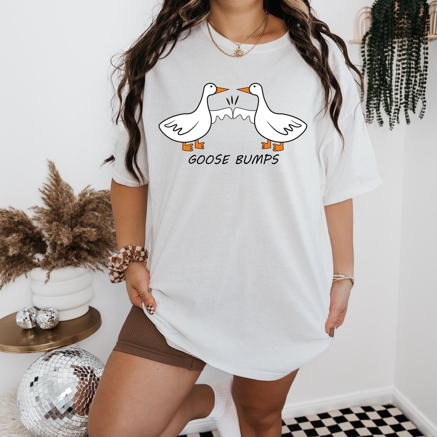 a woman wearing a goose bumps t - shirt