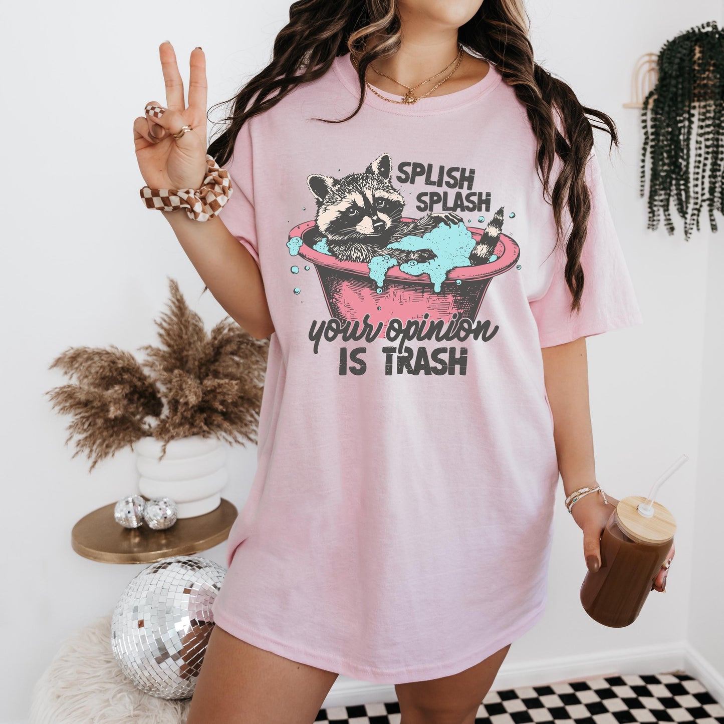 a woman in a pink shirt holding a cup of coffee