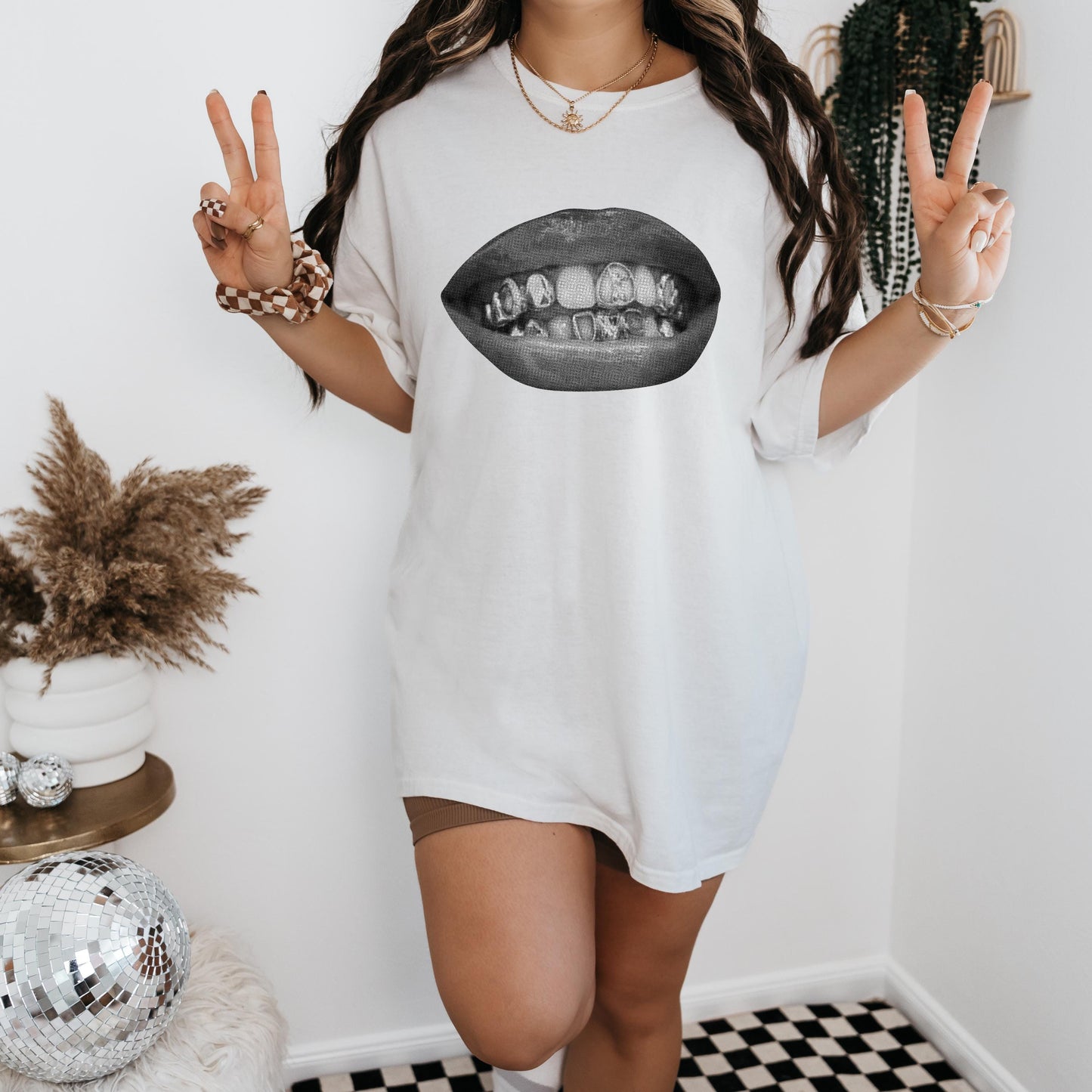 a woman wearing a white shirt with a picture of a mouth on it