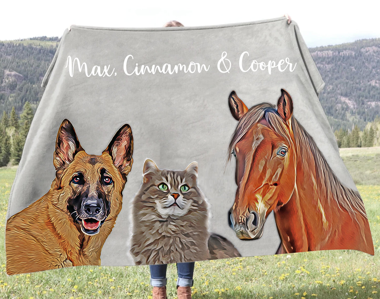 a woman holding a blanket with three horses and a cat