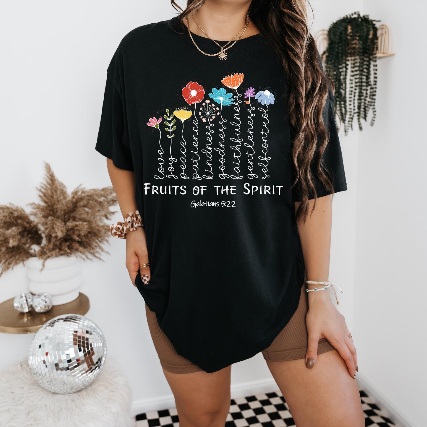 a woman wearing a black shirt with flowers on it