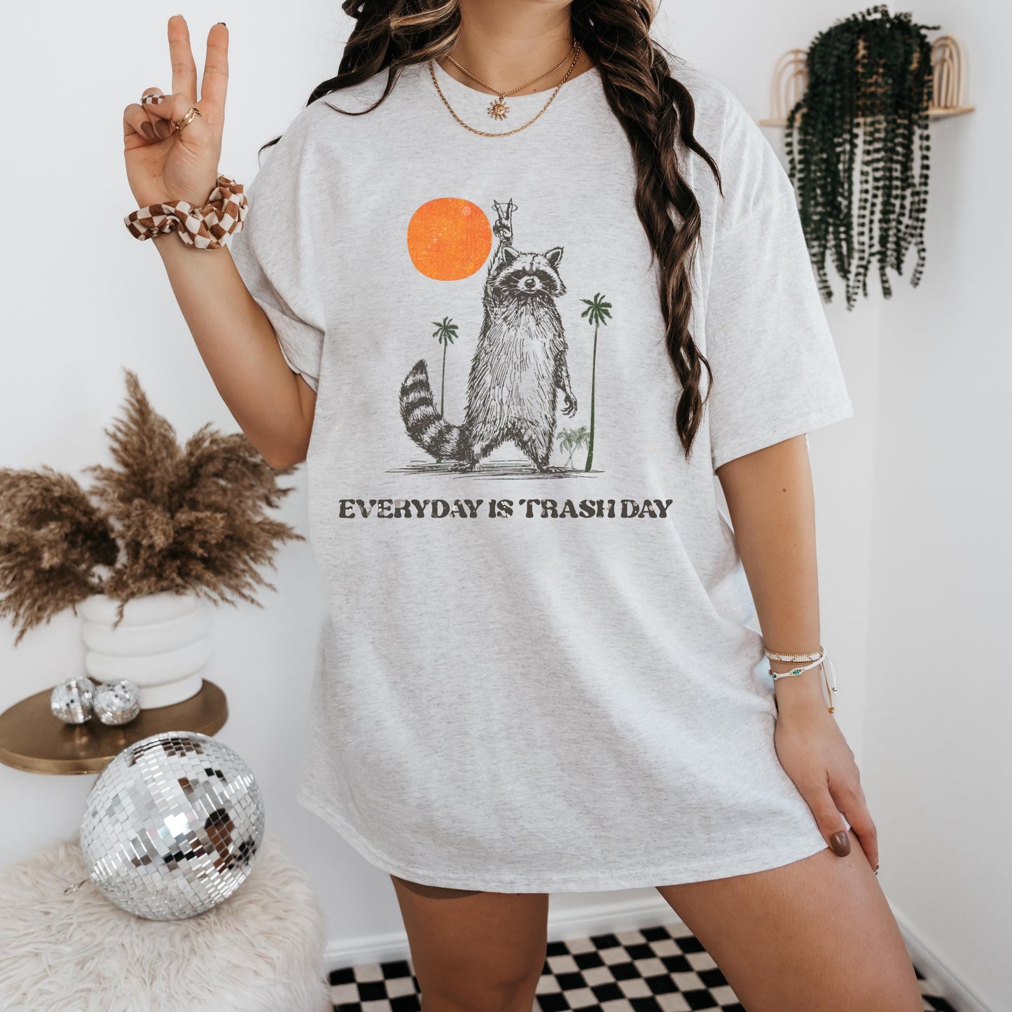 a woman standing in a room with a peace sign