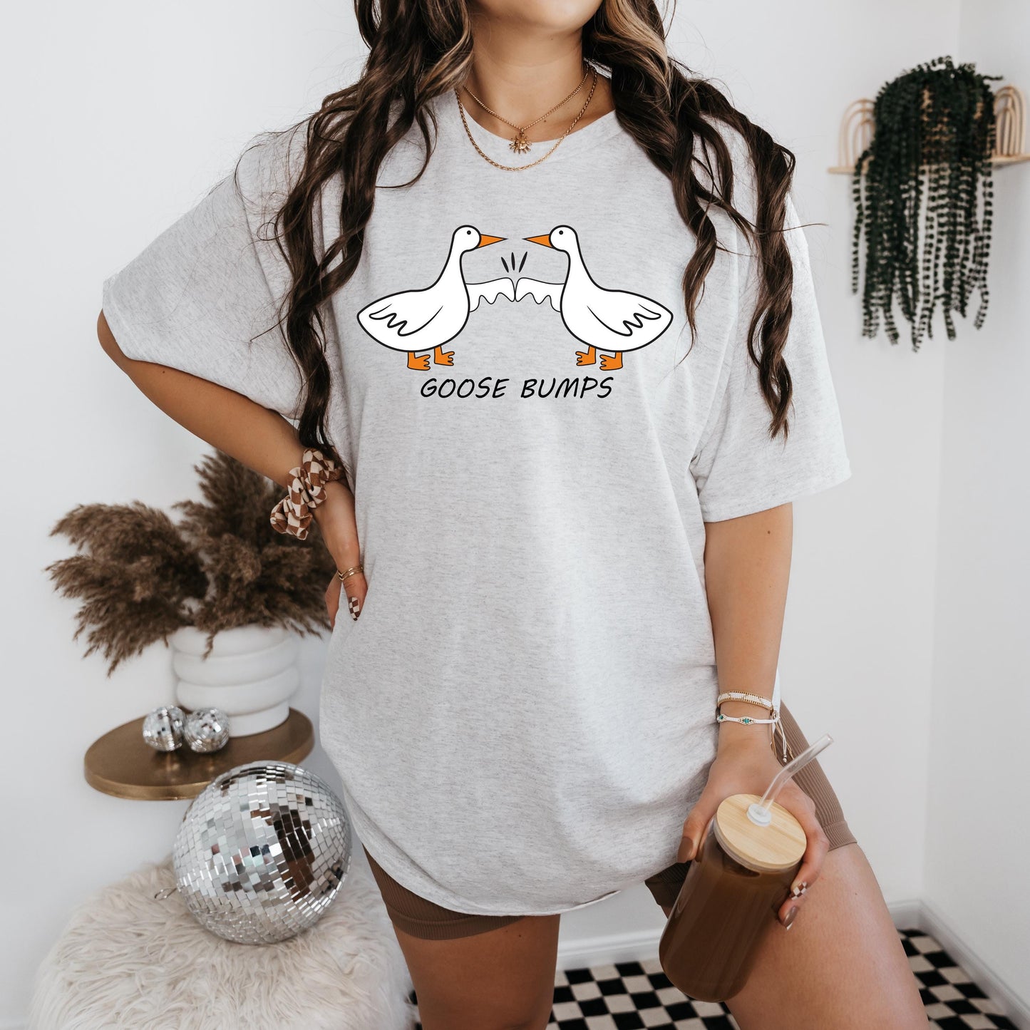 a woman wearing a goose bumps t - shirt