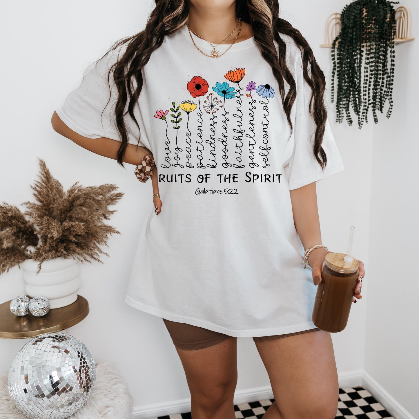 a woman wearing a white shirt with flowers on it
