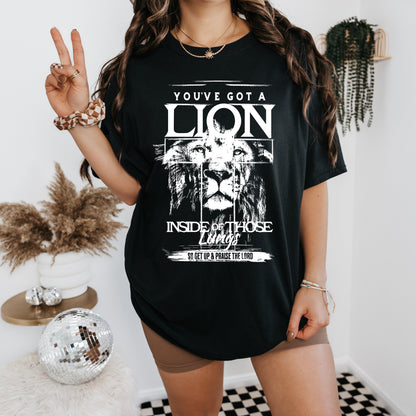 a woman wearing a black shirt with a lion on it