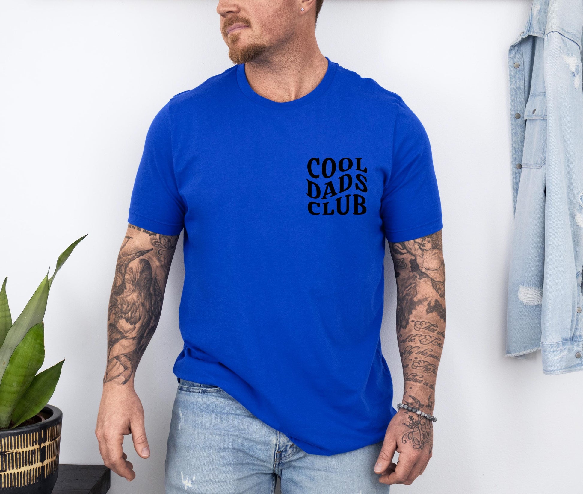 a man wearing a blue shirt with the words cool dads club on it