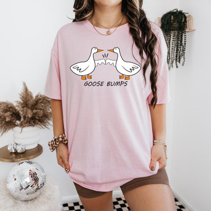 a woman wearing a pink goose bumps t - shirt