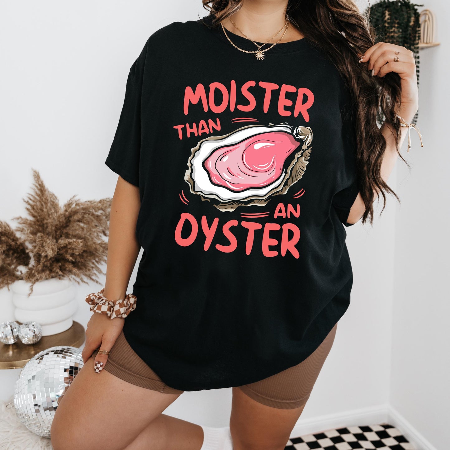 a woman wearing a black t - shirt that says, monster than an oyster