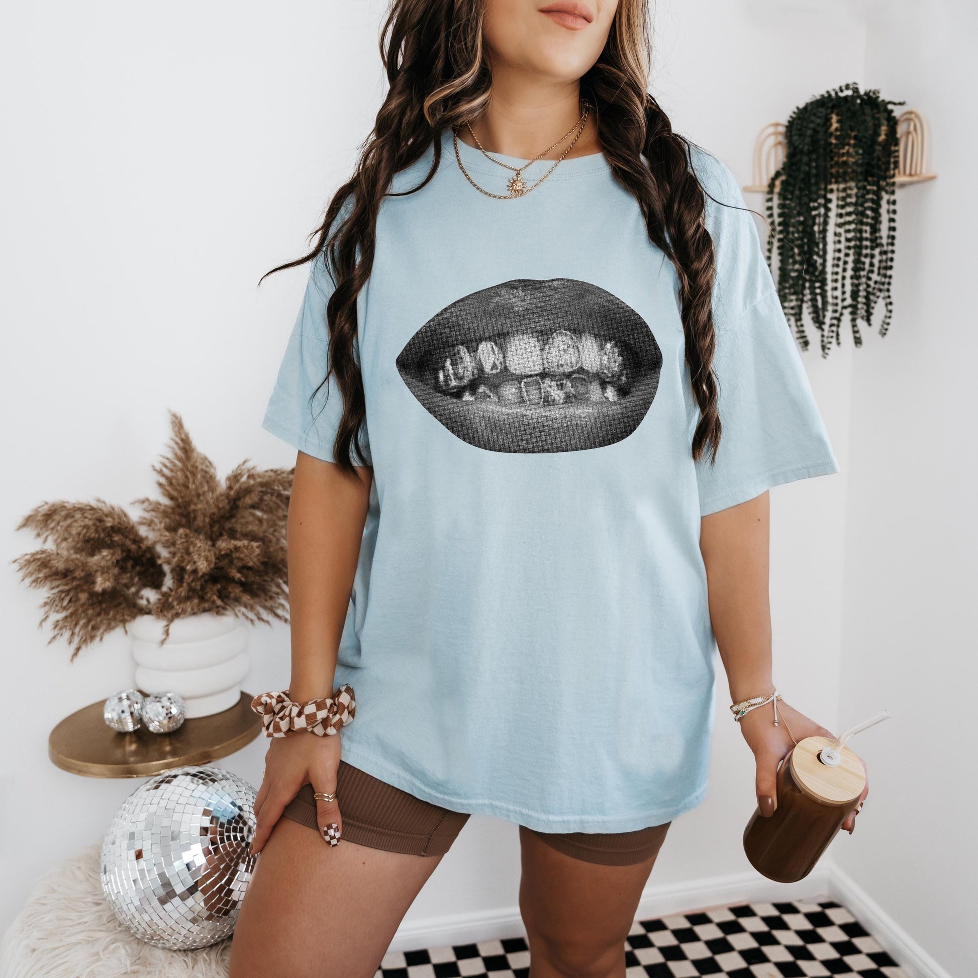 a woman with long hair wearing a blue t - shirt with an image of a