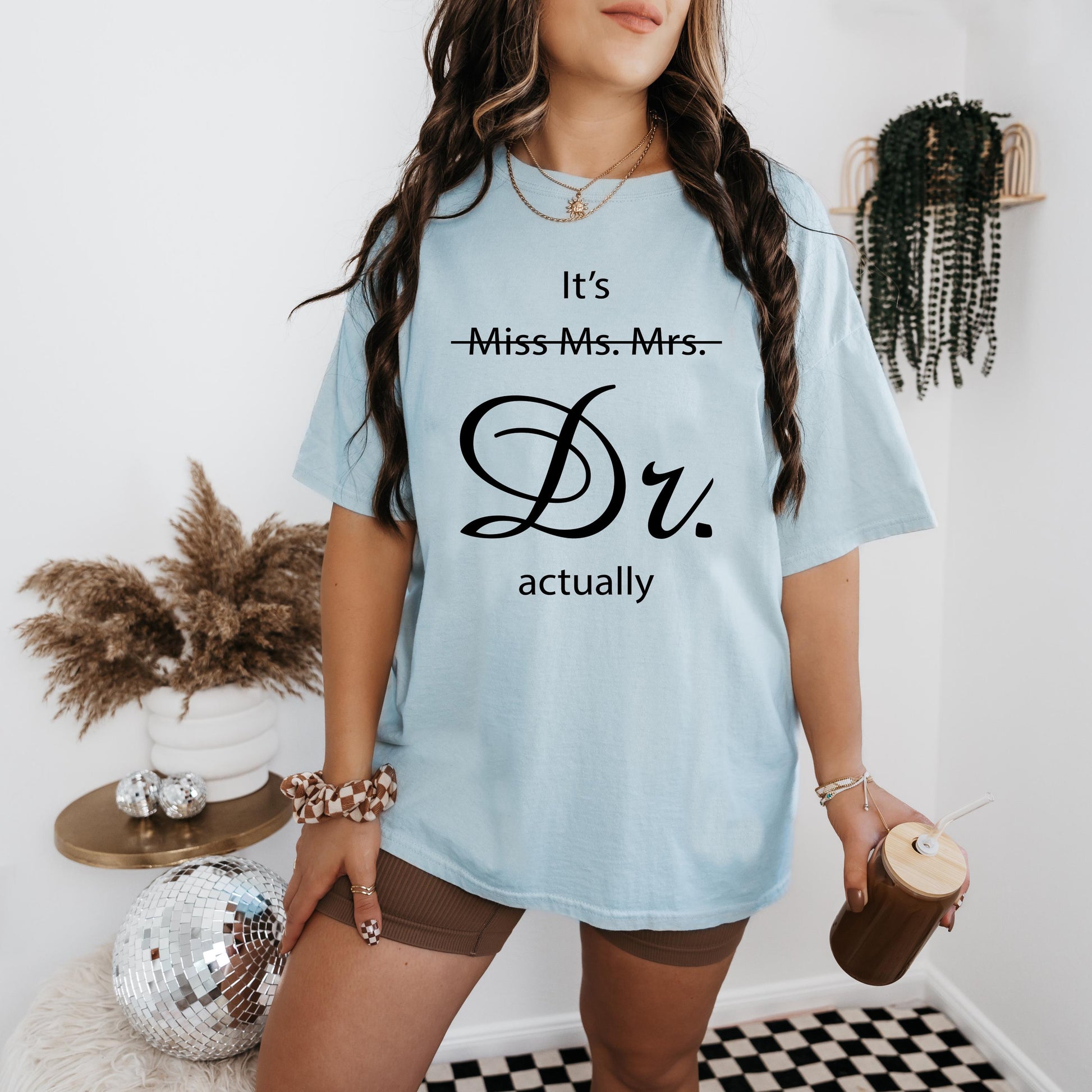 a woman wearing a t - shirt that says it's miss - mrs dr