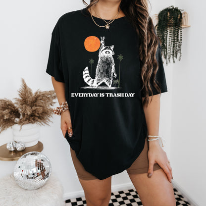 a woman wearing a black shirt with a picture of a raccoon on it