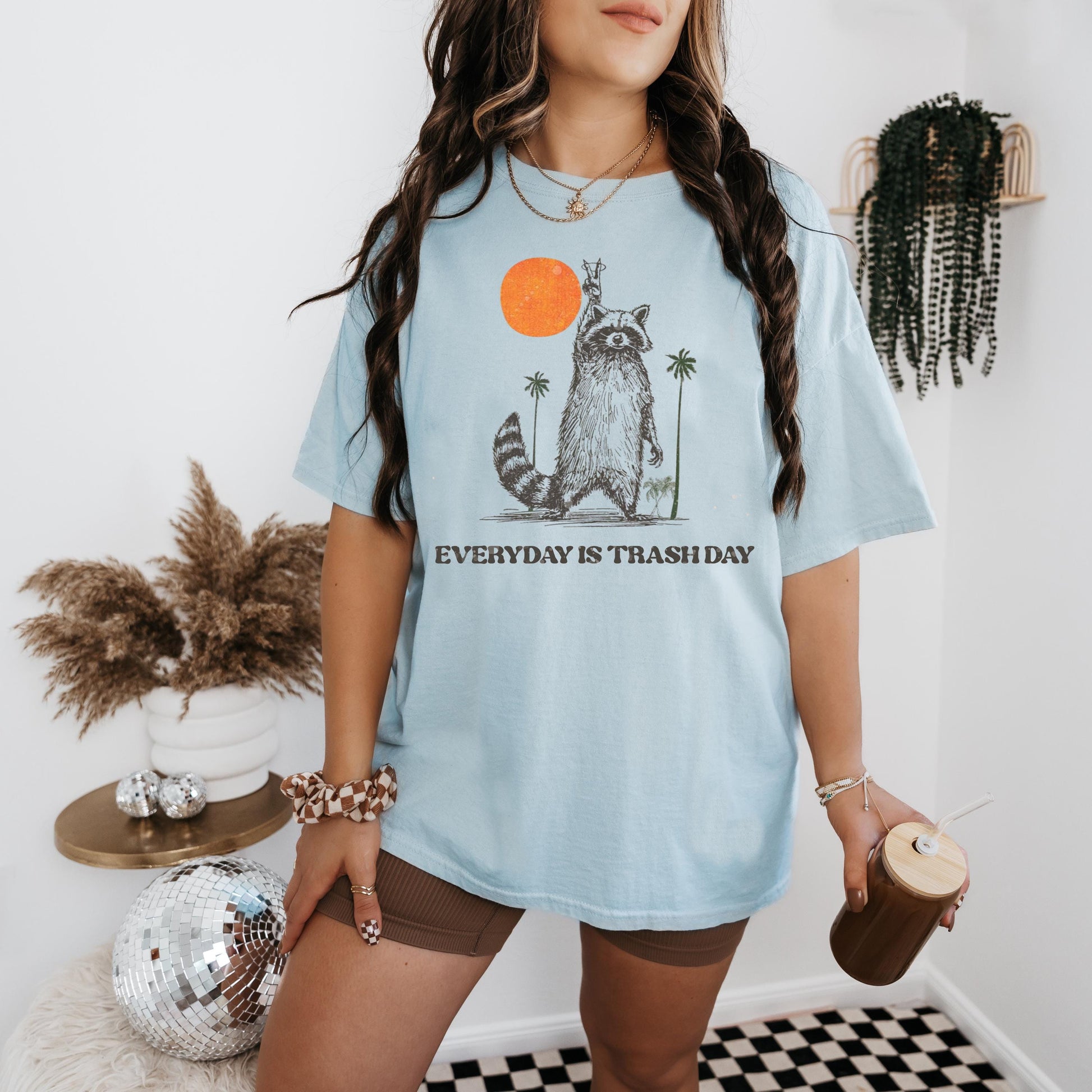 a woman wearing a blue shirt with a raccoon on it