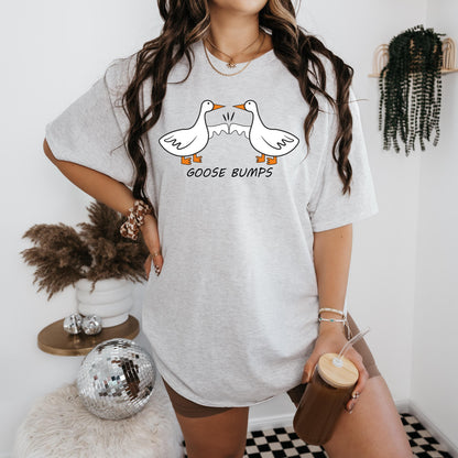 a woman wearing a goose bumps t - shirt