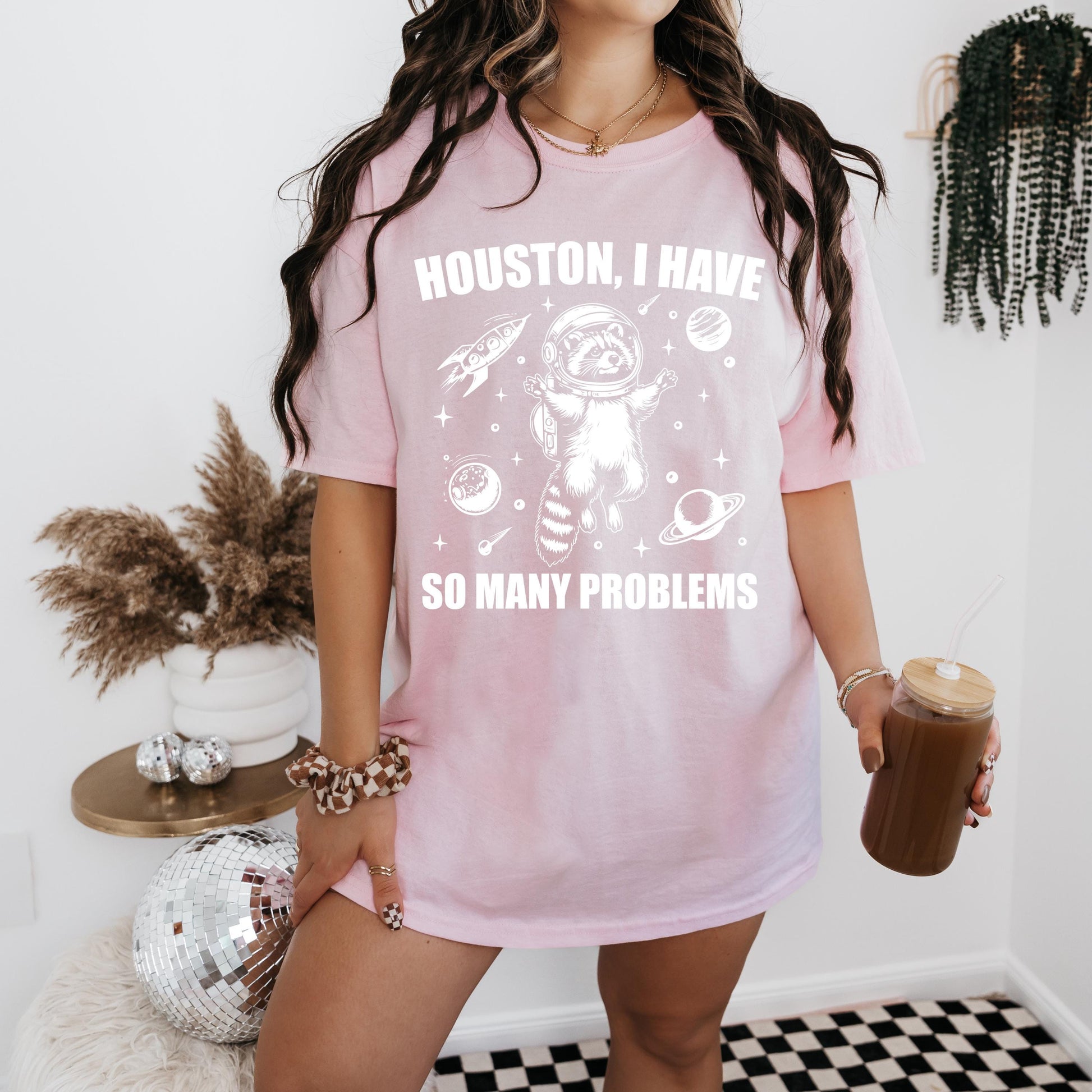 a woman in a pink shirt holding a cup of coffee
