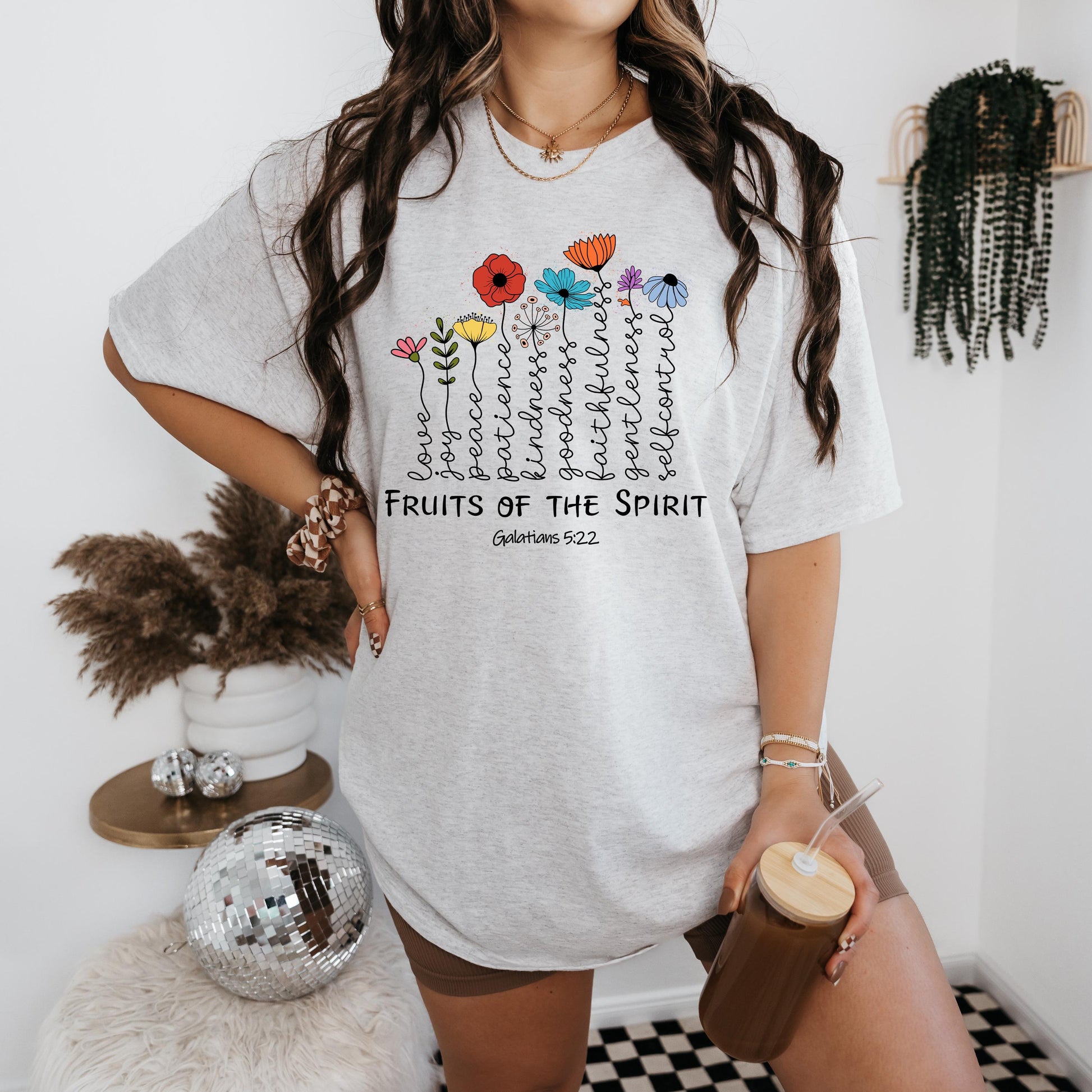 a woman standing in a room holding a cup of coffee